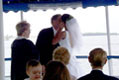 bride and groom kiss after vows